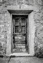 Vertical grayscale shot of a door at the Eastern State Penitentiary in Philadelphia, Pennsylvania Royalty Free Stock Photo