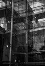 Vertical grayscale shot of a glass wall of a modern office building in Manchester. Royalty Free Stock Photo