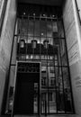 Vertical grayscale shot of the Grand Conseil entrance with a mirror reflection in the glass. Royalty Free Stock Photo