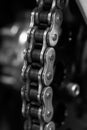 Vertical grayscale shot of the links on a motorcycle chain. Royalty Free Stock Photo
