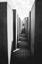 Vertical grayscale shot of a narrow space between walls