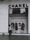 Vertical grayscale shot of a person cleaning the Chanel storefront window Ho Chi Minh City,Vietnam