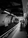 Vertical grayscale of a subway in a station in London