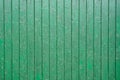 Green color old wooden weathered barn board with vertical planks covered with peeled paint Royalty Free Stock Photo