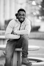 Vertical greyscale shot of an attractive African American male smiling at the camera Royalty Free Stock Photo