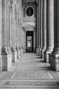 Vertical greyscale shot of the columns of Musee du Louvre, Paris, France