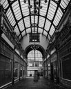 Vertical greyscale shot of a shopping arcade in the city of Birmingham