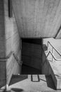 Vertical greyscale shot of stairs leading to a dark basement Royalty Free Stock Photo