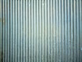 Vertical grooved metal surface, possibly iron, exhibiting evenly spaced ridges. Royalty Free Stock Photo