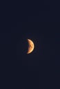Vertical of the half-moon shining bright in the dark night sky for wallpapers and backgrounds Royalty Free Stock Photo