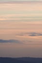 Vertical hazy sunset. Horizon under warm and faded pastel colours