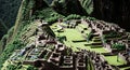 Explore Machu Picchu as the camera pans down the steep clay terraces and steps of this ancient site in Peru revealing its rich Royalty Free Stock Photo
