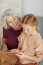 Senior Woman Using Tablet with Girl Royalty Free Stock Photo