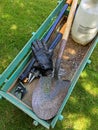 Vertical high angle shot of agricultural tools in a wagon shovel in a garden