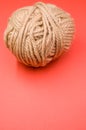 Vertical high angle shot of a ball of yarn on a red surface Royalty Free Stock Photo