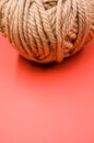 Vertical high angle shot of a ball of yarn on a red surface Royalty Free Stock Photo