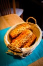 Vertical high angle shot of a basket with fresh loaves of bread with seeds Royalty Free Stock Photo