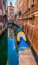 Vertical high angle shot of the boats in a canal in Venice, Italy