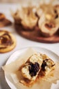 Vertical high angle shot of a delicious chocolate muffin near some muffins and donuts on a table