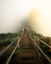 Vertical high angle shot of a male climbing up the stairs on a hill - overcoming challenges concept Royalty Free Stock Photo