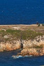 Vertical high angle shot of a rock formation in the blue sea in Coruna, Galicia, Spain Royalty Free Stock Photo