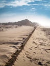 Vertical high angle shot of the sandy ground under the bright cloudy sky Royalty Free Stock Photo