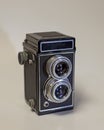 Vertical high angle shot of a vintage twin-lens camera on a white background