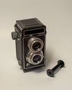 Vertical high angle shot of a vintage twin-lens camera on a white background