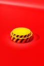 Vertical high-angle view of the 3D-rendered yellow-striped display over the red background