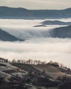 Vertical high angle view of mountaintops surrounded by clouds