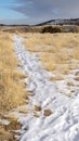 Vertical Hiking trails covered with snow overlooking scenic hills and lake in winter