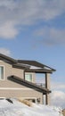 Vertical Home against cloudy blue sky at the snowy neighborhood of Wasatch Mountain