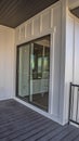 Vertical Home balcony with wooden floor metal railing and sliding glass access door