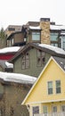 Vertical Home exteriors with horizontal wall siding and thick snow on the roofs