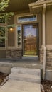 Vertical Home facade with view of yard garage door porch and front door on a sunny day