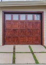 Vertical Home in San Diego California with glass paned garage door beside wooden gate