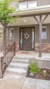 Vertical Home with stairs leading to porch and door flanked with sidelights and windows Royalty Free Stock Photo