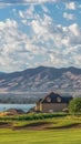 Vertical Homes amid a golf course pond and lake with view of towering mountain and valley Royalty Free Stock Photo