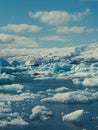 Vertical of icebergs floating in the sea on a sunny day