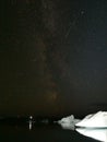 Vertical of icebergs under a dark starry night in Iceland