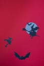 Vertical illustration of witches flying on brooms on full Moon an a red background