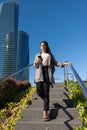 Adult woman walking down on public staircase in the city using phone Royalty Free Stock Photo