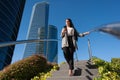 Adult woman walking down on public staircase in the city using phone Royalty Free Stock Photo