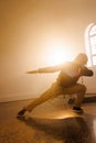 Vertical image of biracial male hip hop dancer dancing in smoked interior Royalty Free Stock Photo