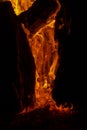 Vertical image of a burning log creating a fiery background Royalty Free Stock Photo