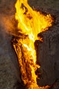 Vertical image of a burning log creating a fiery background Royalty Free Stock Photo