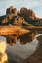 Vertical image of cathedral rock seen from secret slickrock in Sedona Arizona with reflection of geological sandstone rock