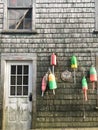 Vertical image of colorful lobster buoys hanging on the side of a wooden shack in  a village in Maine, USA Royalty Free Stock Photo