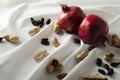 Vertical image.Dark and shadows, ripe whole pomegranates on the white textile Royalty Free Stock Photo