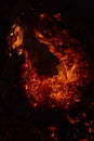 Vertical image of embers of a burning log creating a fiery background Royalty Free Stock Photo